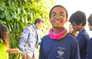 A boy smiles as he holds marine debris he cleaned up from local mangroves in the Florida Keys.